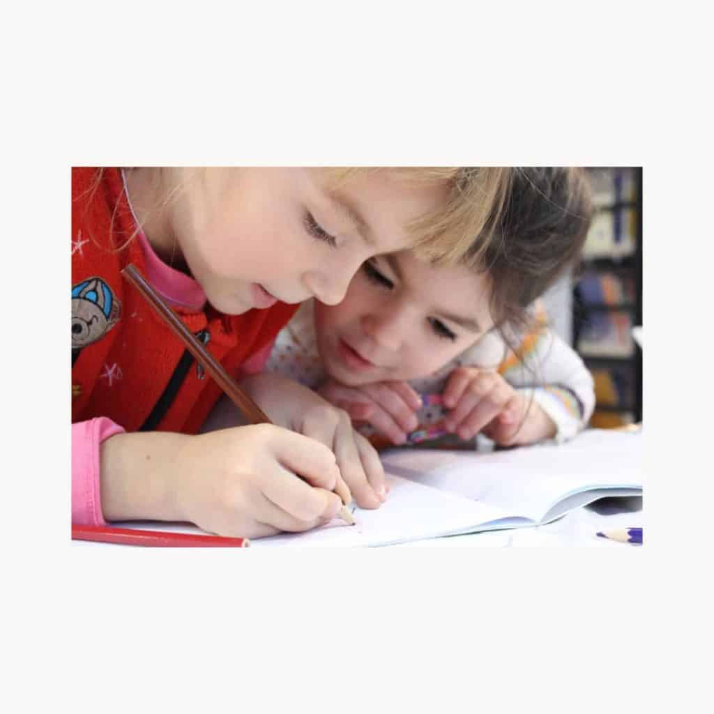 Kids working on a paper with focus